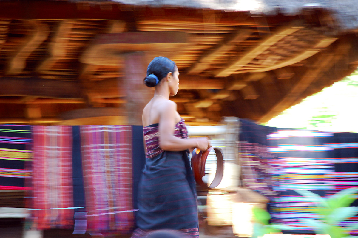 Lady running in Takpala village market, Alor island